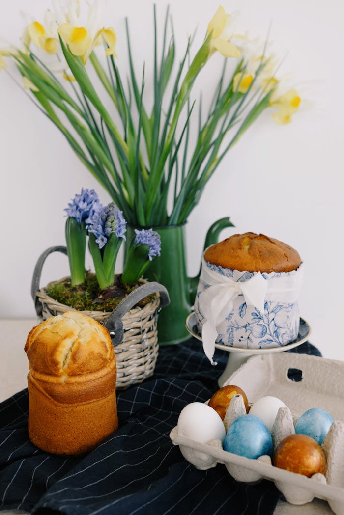 Decorative Easter table setting with baked goods and spring flowers, ideal for holiday themes.